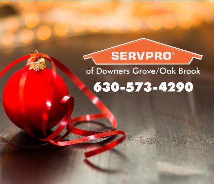 Red ornament with a red ribbon and an orange SERVPRO logo.