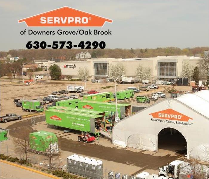 Ariel view of green SERVPRO trucks in a parking lot of a mall.
