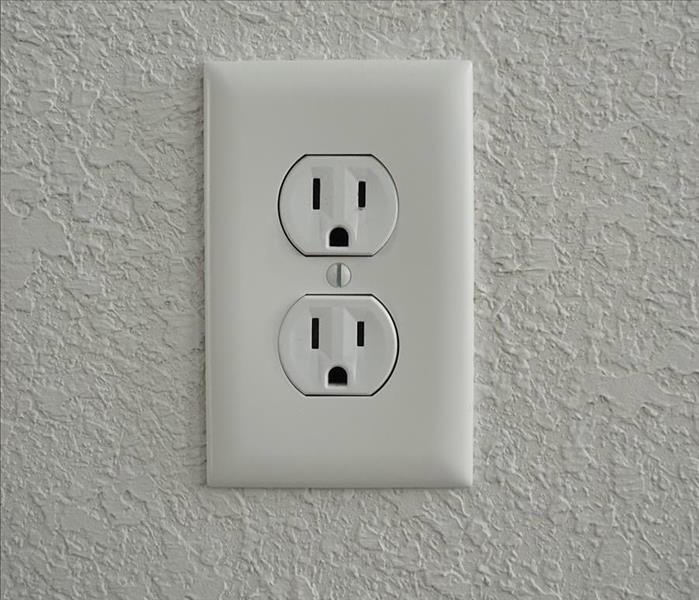 White power outlet on a white wall.