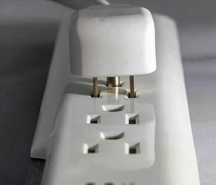 White power strip with a white plug.
