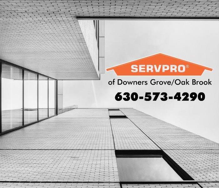 Grey office building with an orange SERVPRO logo.
